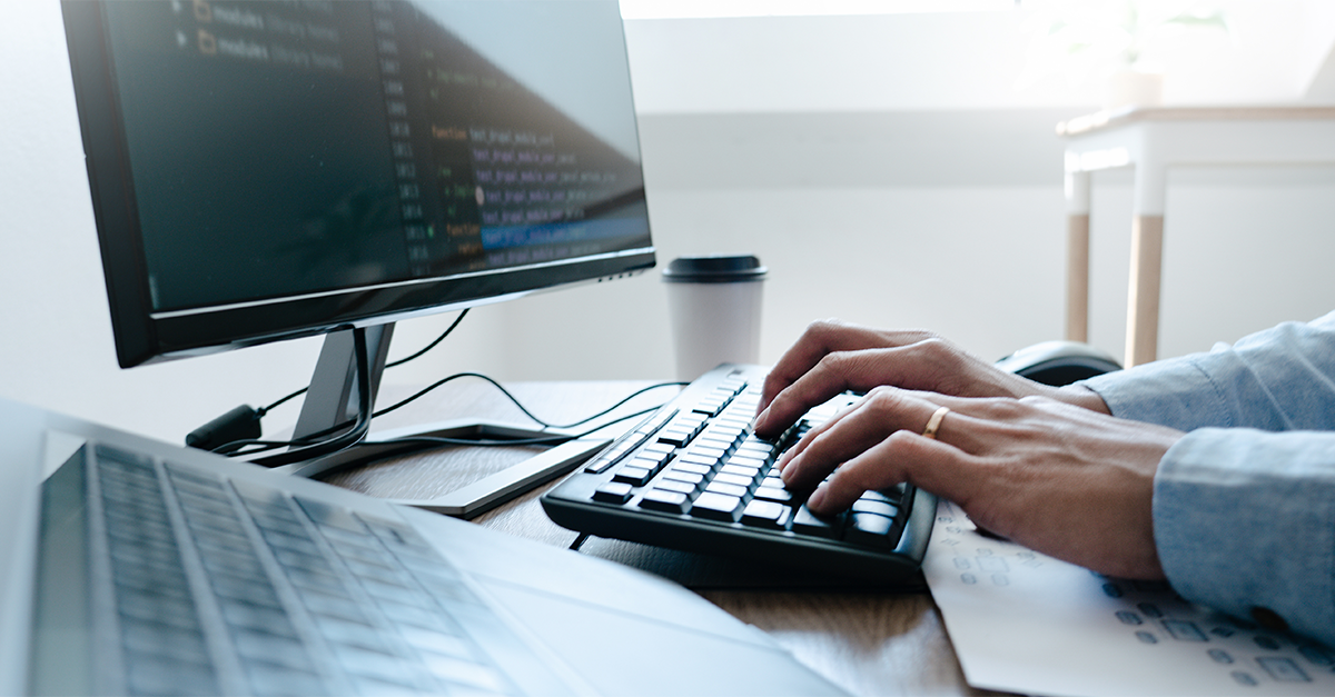 hands typing on a keyboard hands typing on a keyboard
